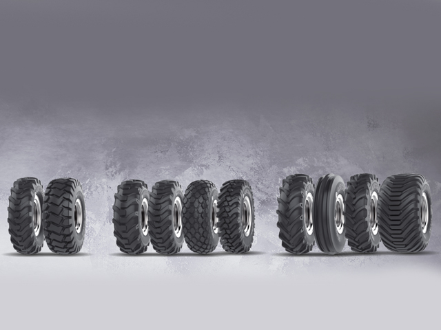 A row of off-highway tyres showcasing various tread patterns and sizes designed for rugged terrain and heavy-duty vehicles.