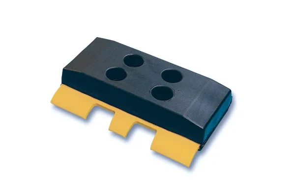 A polyurethane track shoe component with a black upper and yellow lower section, featuring three protruding prongs and four circular holes on the top surface.