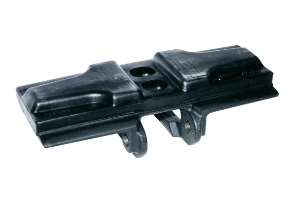 A black track shoe component with a textured surface and two mounting holes on the top.