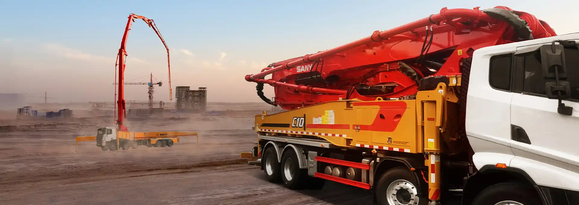 SANY truck-mounted concrete pump operating on a large construction site in UAE. High-capacity concrete pouring equipment from UMHE.